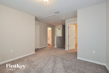 Palm Coast house for rent - the living room of an apartment with carpet and white walls