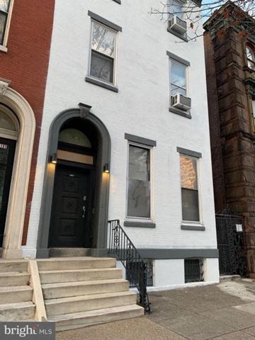Philadelphia apartment for rent - a white house with steps and a black door