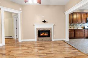 Jersey City apartment for rent - A living room with a fireplace and wooden floors.