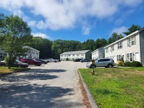 Lewiston apartment for rent - a parking lot filled with cars in front of apartment buildings