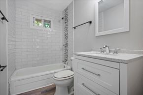 Roswell apartment for rent - A white bathroom with a toilet, sink, and bathtub.
