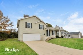 Troy house for rent - a beige house with a white garage door