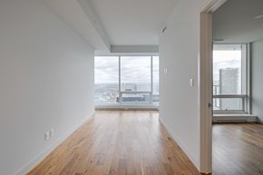 Edmonton apartment for rent - A room with wooden floors and white walls.