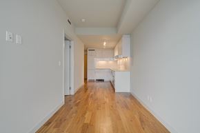Edmonton apartment for rent - A long hallway with a kitchen at the end.