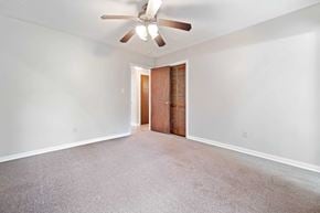 Jacksonville house for rent - A room with a ceiling fan and carpeted floor.