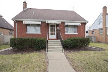 Lansing house for rent - A red brick house with a white door and windows.