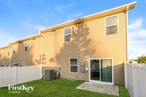 Huntersville house for rent - A FirstKey Homes residential building with a fence and a green lawn.