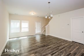 Concord house for rent - A spacious room with wooden floors and a staircase.