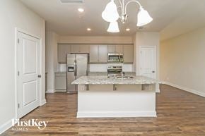 Concord house for rent - A kitchen with a white island and a fridge.