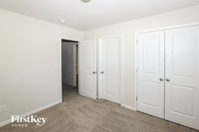 Concord house for rent - a bedroom with three closets and a door to a hallway