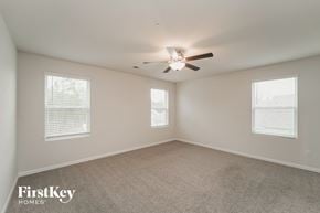 Concord house for rent - a bedroom with a ceiling fan and two windows