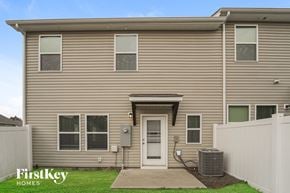 Concord house for rent - the exterior of a home with tan siding and a white door
