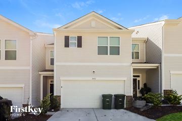 Concord house for rent - a white house with a garage door and a driveway