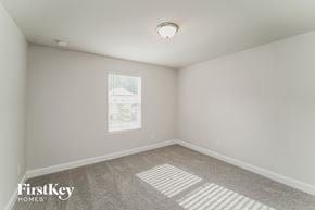 Charlotte house for rent - a bedroom with white walls and carpet and a window