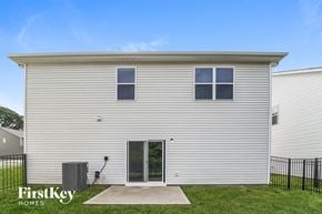 Charlotte house for rent - the exterior of a home with white siding and grass