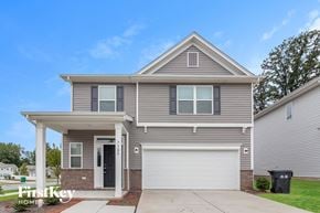 Charlotte house for rent - A grey house with a black door and a white garage door.