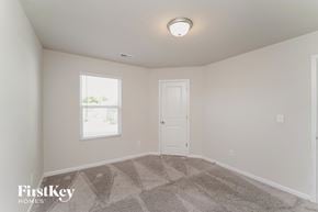 Charlotte house for rent - a bedroom with carpet and a white door and window