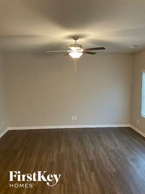 Charlotte house for rent - A room with wooden flooring and a ceiling fan.