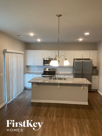 Charlotte house for rent - A kitchen with a granite countertop and stainless steel appliances.