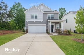 Charlotte house for rent - a blue house with a white garage door and a driveway