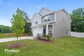 Charlotte house for rent - a house with a lawn and a tree in front of it