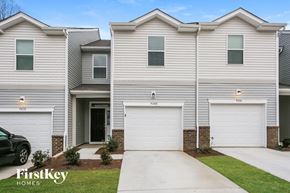 Concord house for rent - a white house with two garage doors