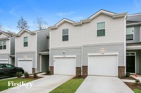 Concord house for rent - a white house with two garage doors