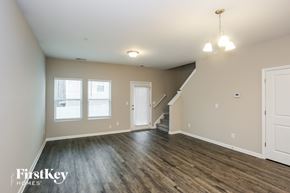 Concord house for rent - the living room and dining room of an empty house with wood flooring
