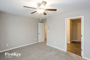 Concord house for rent - a bedroom with a ceiling fan and a door to a hallway
