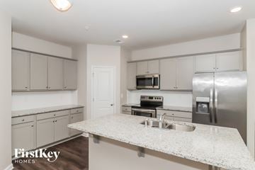 Concord house for rent - A kitchen with a granite countertop and stainless steel appliances.