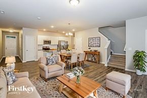 Concord house for rent - A well-lit living room with a dining area and a staircase.