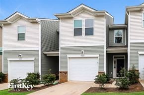 Concord house for rent - a white and gray house with two garage doors