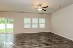 Charlotte house for rent - A room with a ceiling fan and wooden flooring.
