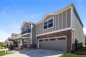 Lewisville house for rent - A modern house with a garage is showcased in the image.