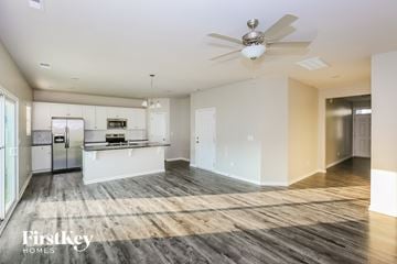 Charlotte house for rent - A spacious kitchen with a refrigerator, microwave, and oven.