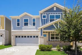 Lewisville house for rent - A modern two-story house with a garage and a tree in front.