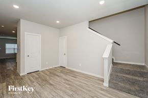 Lewisville house for rent - A room with a staircase and two doors.