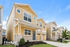 Lewisville house for rent - a row of homes with yellow siding and a sidewalk