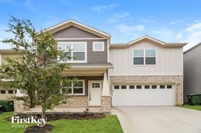 Lewisville house for rent - a home with a white garage door and a brick house