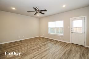 Lewisville house for rent - the spacious living room with hardwood flooring and a ceiling fan