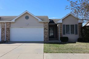 Merrillville house for rent - a white house with a white garage door