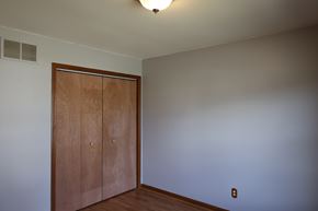 Merrillville house for rent - an empty room with a wooden door and a white wall