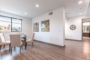 Los Angeles apartment for rent - a dining room with a table and chairs and a clock on the wall