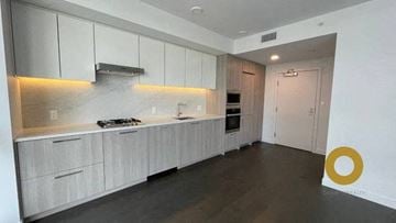 Richmond house for rent - a large white kitchen with white cabinets and a door
