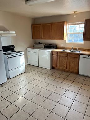 Pasadena apartment for rent - an empty kitchen with white appliances and wooden cabinets
