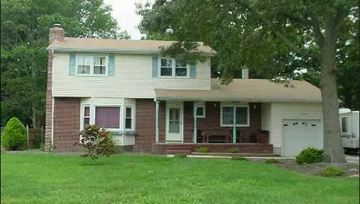 Egg Harbor Township house for rent - a white and brick house with a yard and trees