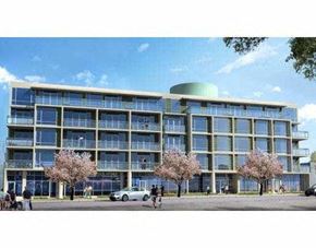 Vancouver apartment for rent - A modern building with a green dome on top and a row of trees in front.