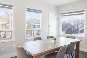 Winnipeg triplex for rent - a dining room with a table and chairs and three windows