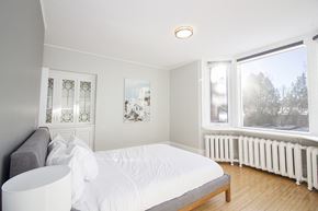 Winnipeg triplex for rent - a white bedroom with a bed and a window