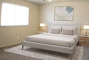 Amarillo apartment for rent - A white bed with a white headboard and two white pillows sits in a room with a white ceiling and a white wall.